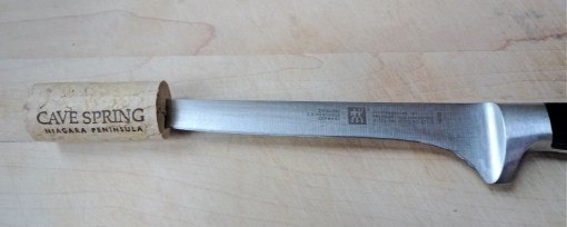 A knife block is best but a cork will protect tips in a pinch